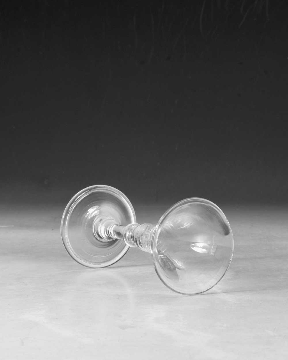 A mid-18th century clear Georgian glass featuring a flared trumpet bowl, a knopped stem, and a broad circular foot. View IV