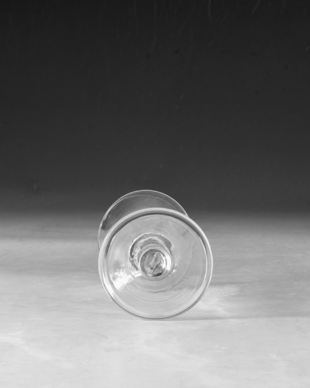 A mid-18th century clear Georgian glass featuring a flared trumpet bowl, a knopped stem, and a broad circular foot. View V