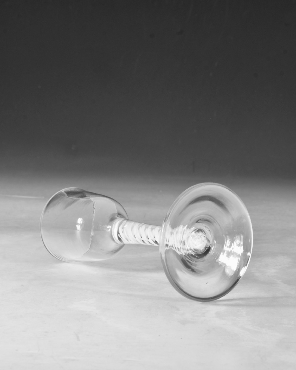 A clear Georgian lead glass wine glass featuring a tall bowl, an intricate white opaque twist stem, and a circular flat foot. View III