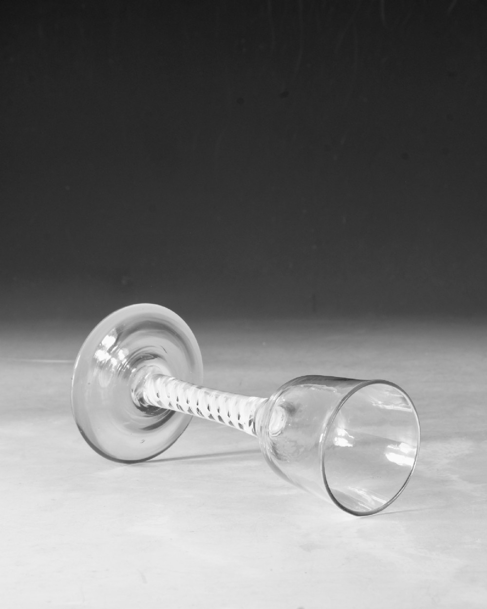 A clear Georgian lead glass wine glass featuring a tall bowl, an intricate white opaque twist stem, and a circular flat foot. View IV