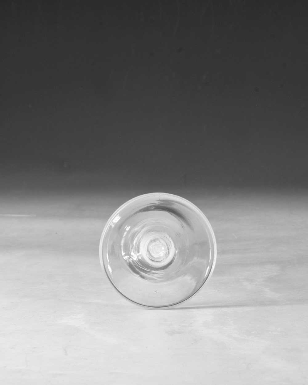 A clear Georgian lead glass wine glass featuring a tall bowl, an intricate white opaque twist stem, and a circular flat foot. View V