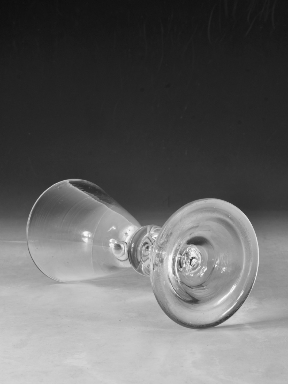 A hand-blown clear lead glass baluster wine goblet featuring a bell bowl, knopped stem with an air tear inclusion, and a folded conical foot. View IV