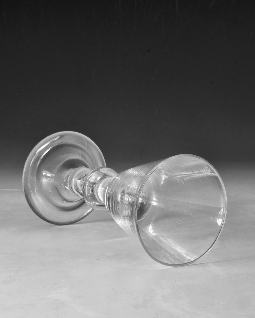 A hand-blown clear lead glass baluster wine goblet featuring a bell bowl, knopped stem with an air tear inclusion, and a folded conical foot. View V