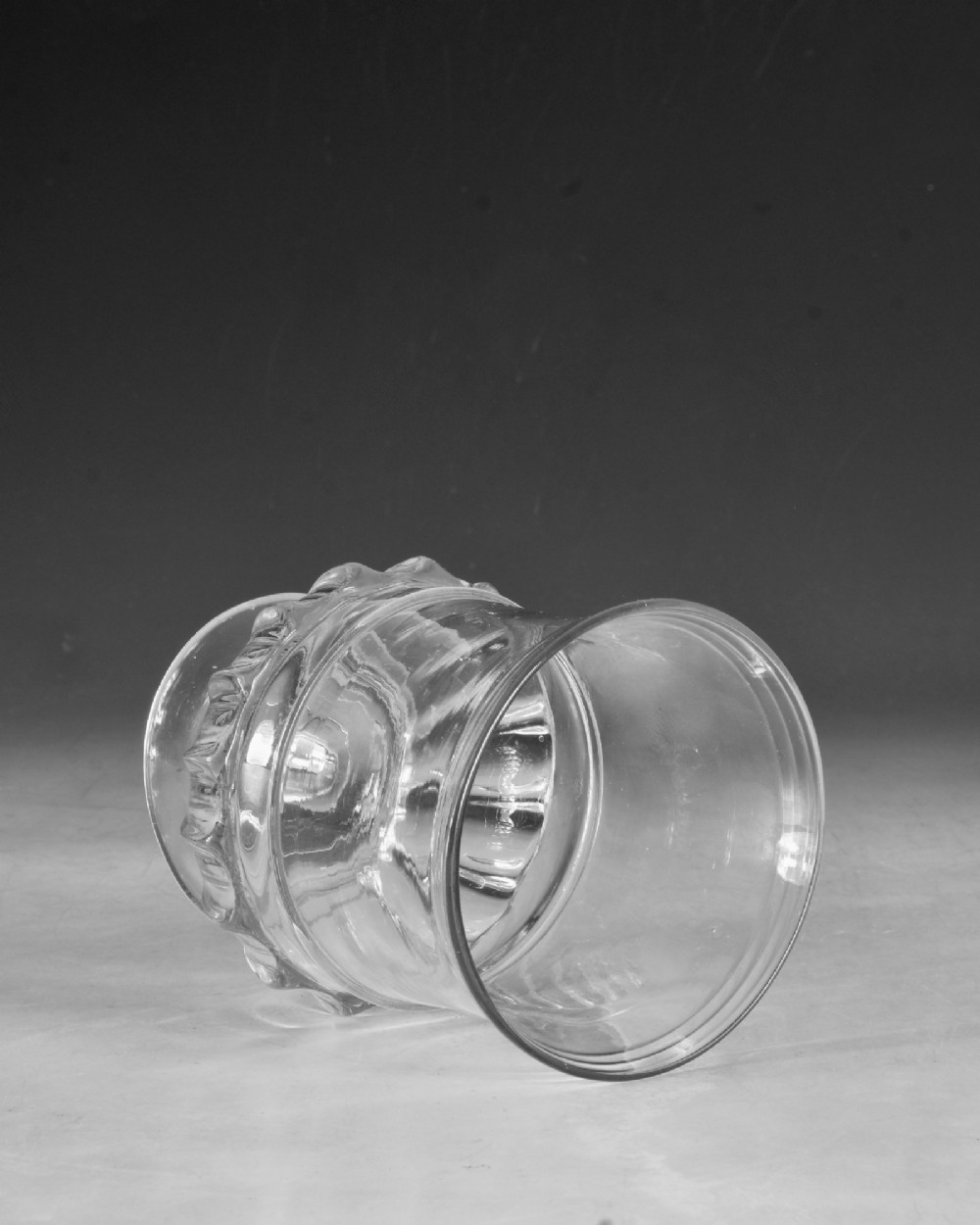 A clear 18th-century Georgian glass drinking vessel featuring a flared rim, a ribbed lower body, and a low circular pedestal base. View IV