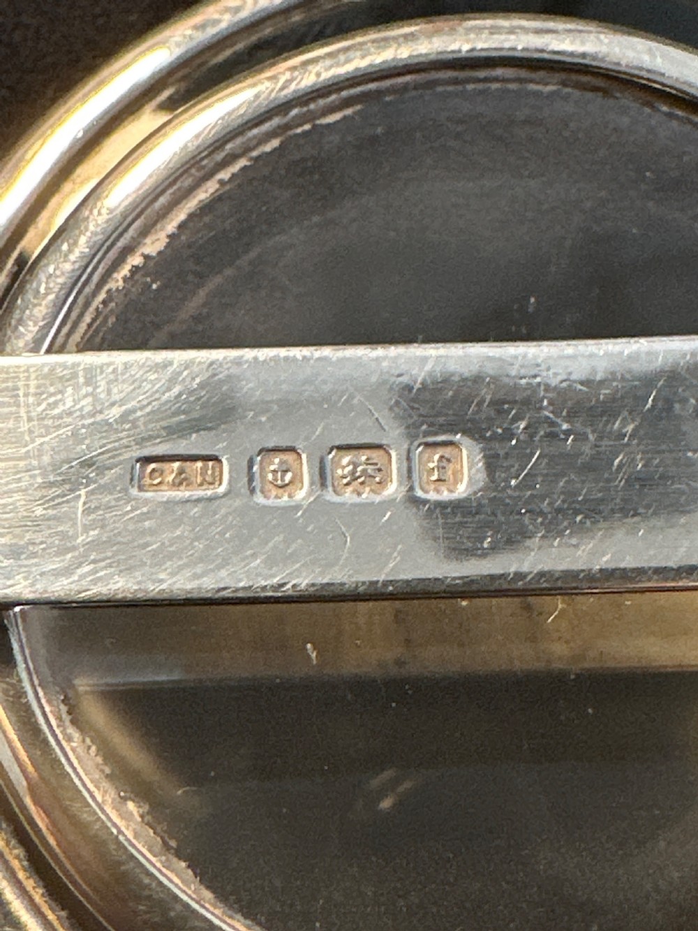An Edwardian hallmarked sterling silver folding double-lens magnifying glass with two circular lenses attached to a hinged handle. View III