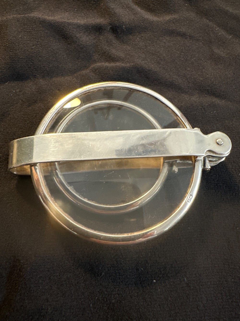 An Edwardian hallmarked sterling silver folding double-lens magnifying glass with two circular lenses attached to a hinged handle. View IV