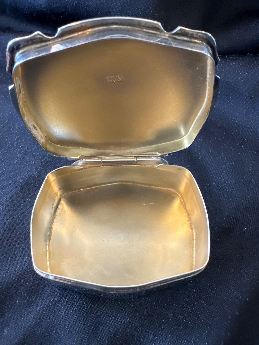 An Edwardian sterling silver shaped box with engine-turned geometric detailing on the lid and a central plain circular cartouche. View VIII