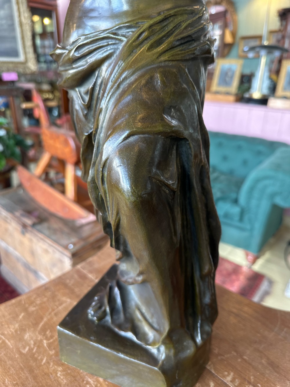 A 19th-century dark brown bronze sculpture depicting the Venus de Milo standing on an integral rectangular base. View VII
