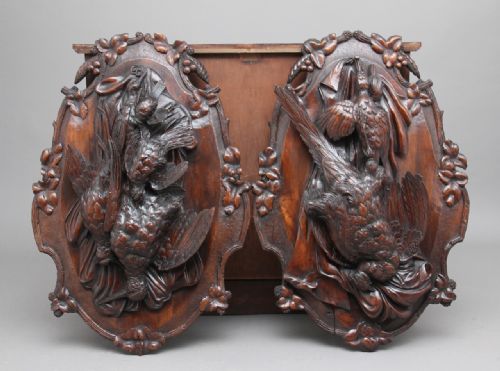 A Pair of 19th Century Walnut Black Forest Wall Plaques