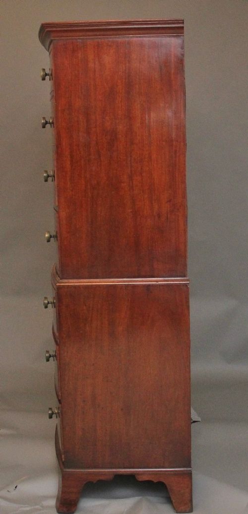 An early nineteenth-century mahogany bow-front tallboy featuring seven stacked drawers with turned brass handles. View XII