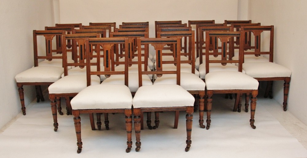 A set of 24 oak dining chairs