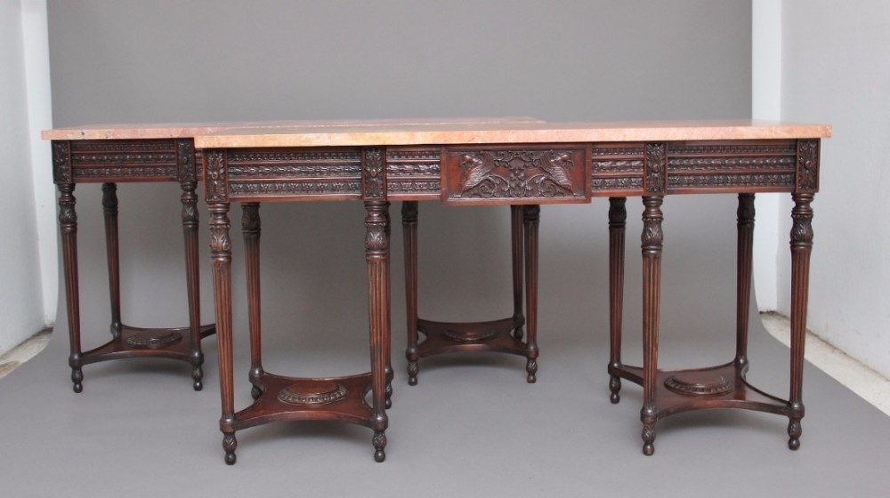 A pair of early 20th Century mahogany and marble top console tables