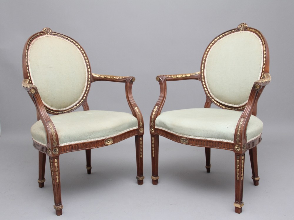 A pair of early 20th Century mahogany open armchairs