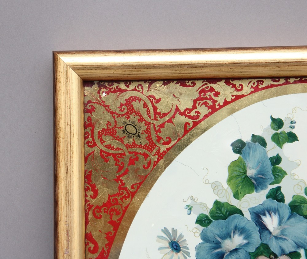 A pair of early 19th-century framed botanical paintings depicting colourful floral bouquets within oval apertures surrounded by red and gold patterned borders. View III