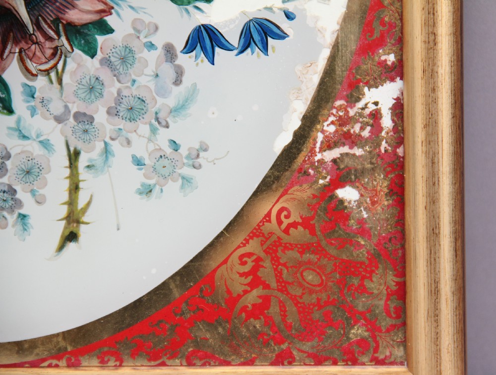 A pair of early 19th-century framed botanical paintings depicting colourful floral bouquets within oval apertures surrounded by red and gold patterned borders. View VI