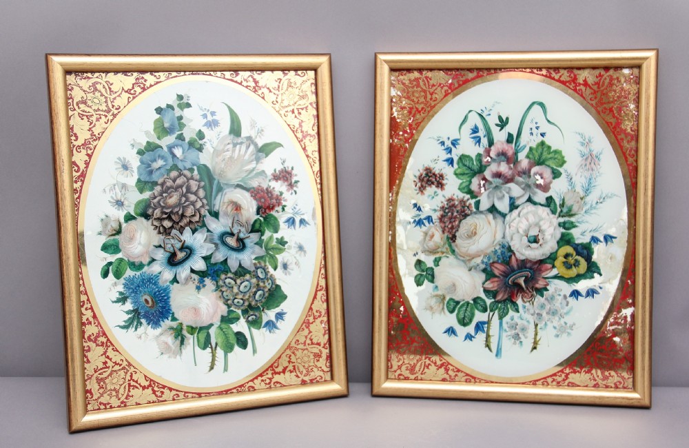 A pair of early 19th-century framed botanical paintings depicting colourful floral bouquets within oval apertures surrounded by red and gold patterned borders. View IX