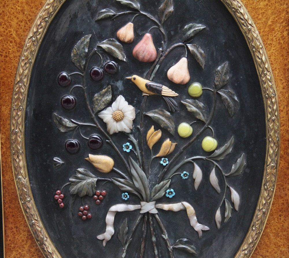 A 19th-century ebonised and amboyna wood credenza featuring central doors with oval pietre dure panels, porcelain medallion inserts, gilt bronze mounts, and curved glass side compartments. View XIV