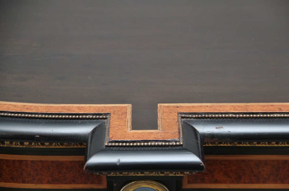 A 19th-century ebonised and amboyna wood credenza featuring central doors with oval pietre dure panels, porcelain medallion inserts, gilt bronze mounts, and curved glass side compartments. View XXVII