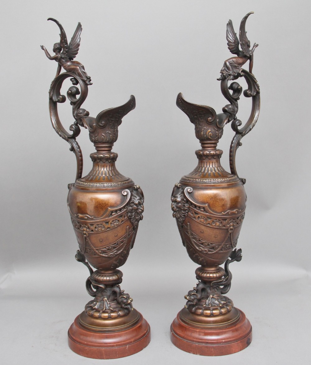 A pair of 19th Century bronze and marble ewers