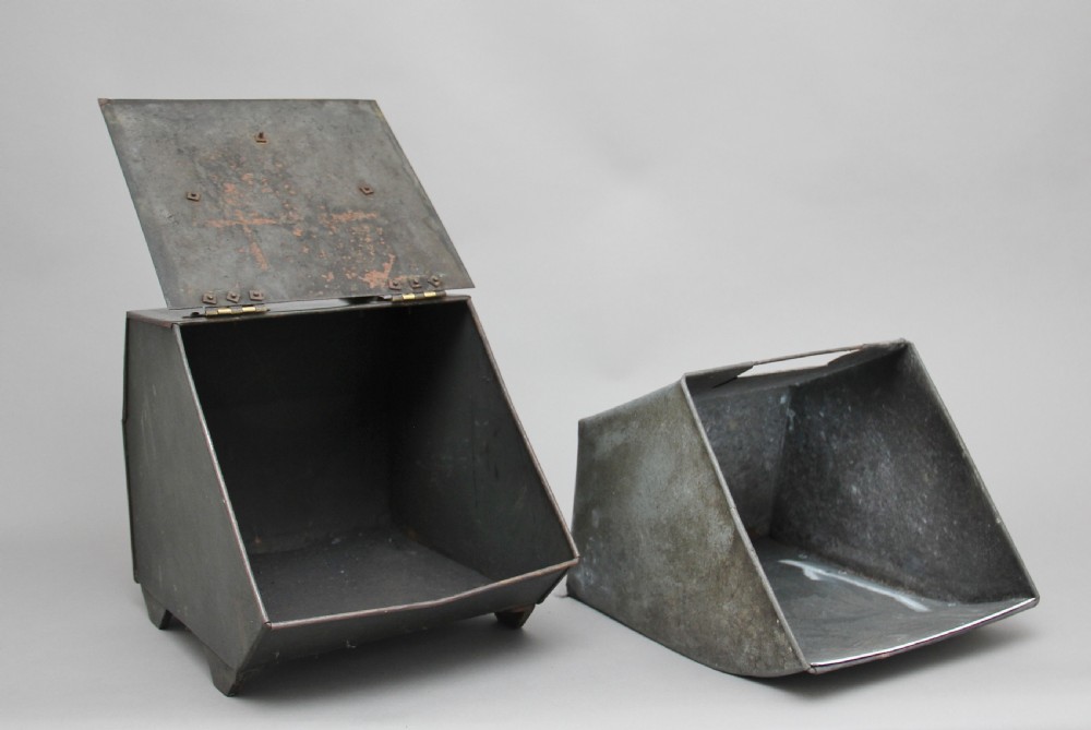 A nineteenth-century black metal coal box featuring a slanted drop front decorated with hand-painted pink flowers, brass strap hinges, a brass knob, and a top carrying handle. View III