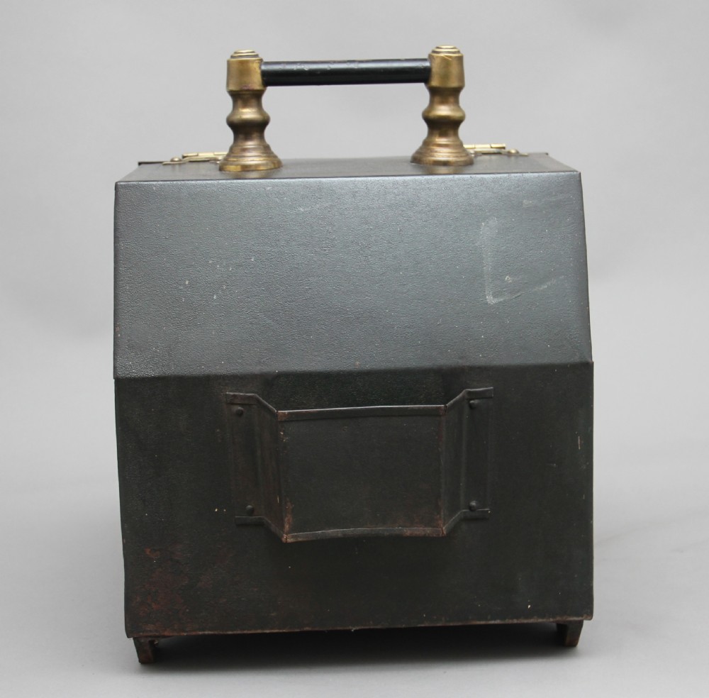 A nineteenth-century black metal coal box featuring a slanted drop front decorated with hand-painted pink flowers, brass strap hinges, a brass knob, and a top carrying handle. View VIII