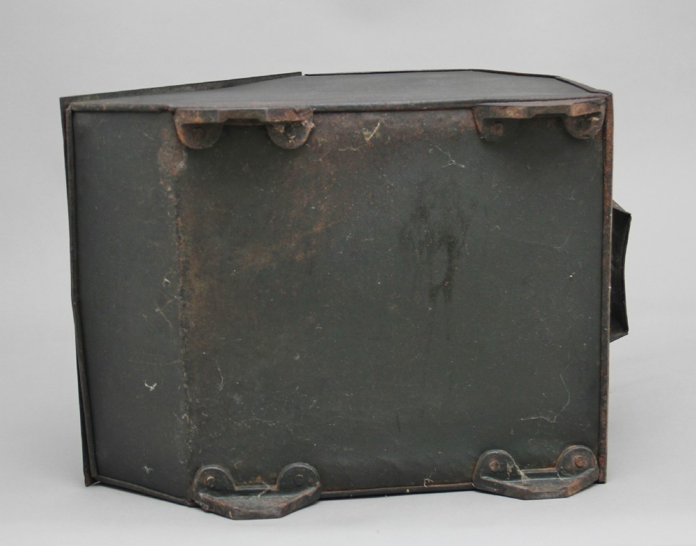 A nineteenth-century black metal coal box featuring a slanted drop front decorated with hand-painted pink flowers, brass strap hinges, a brass knob, and a top carrying handle. View X