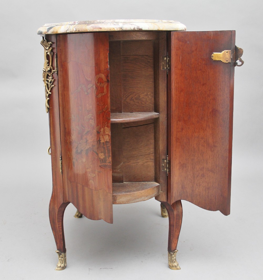 An early 19th-century French marquetry cabinet with a curved front, marble top, detailed wood inlay depicting a scenic landscape, and ornamental brass mounts. View XIII