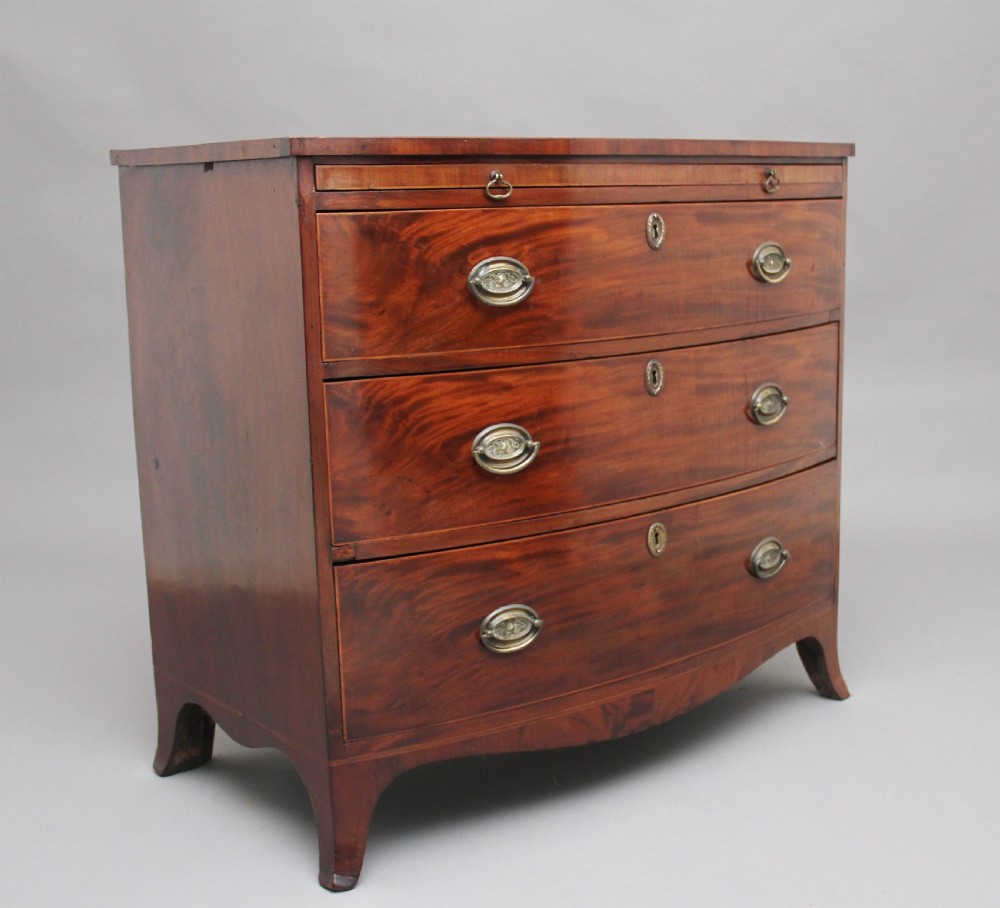 Early 19th Century mahogany bowfront chest with slide View II