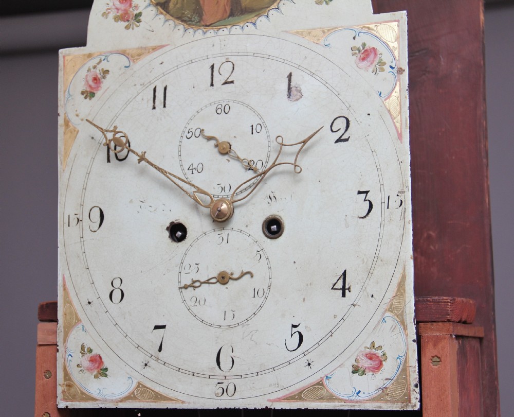 A 19th-century mahogany longcase clock featuring a swan-neck pediment hood, an arched painted clock dial, a flame mahogany trunk door with marquetry inlay, and a plinth base. View V