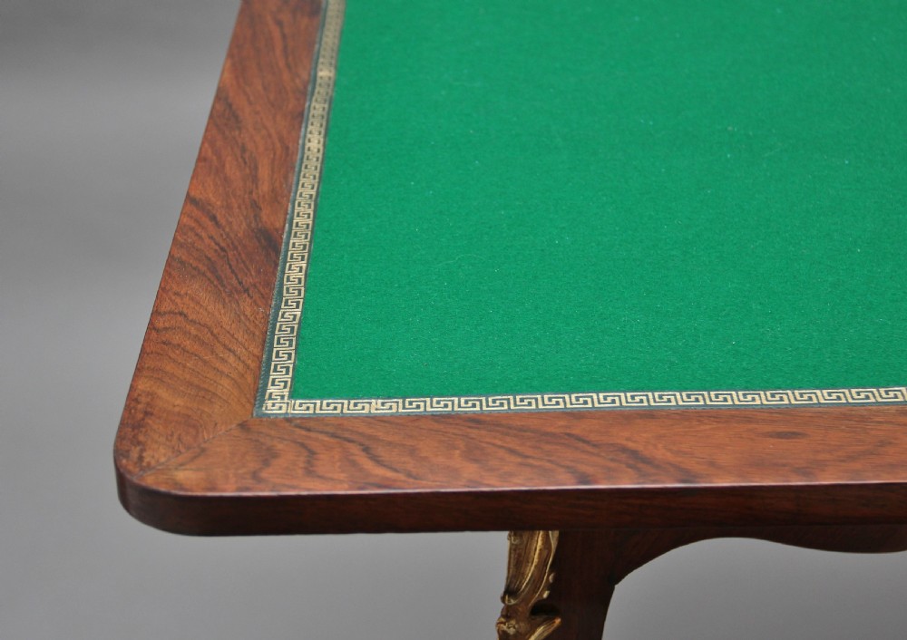 A 19th-century French Rococo revival kingwood fold-over card table with floral marquetry inlay, cabriole legs, and ornate gilt ormolu mounts. View VII