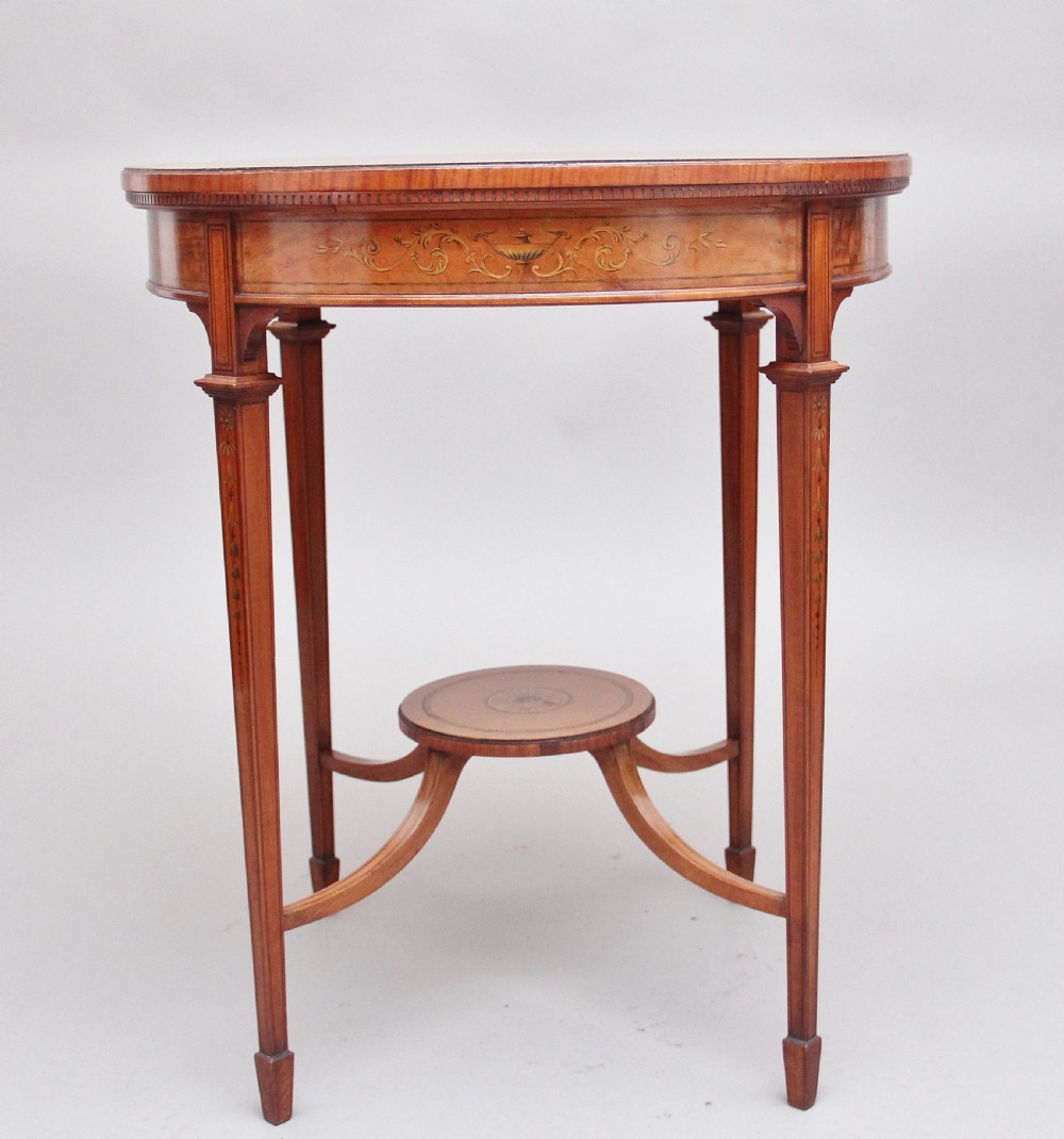 An oval 19th-century satinwood occasional table featuring floral marquetry along the apron, tapered square legs, and a small circular undertier. View III