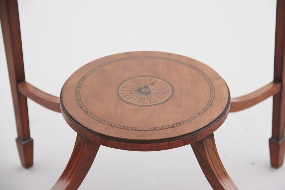 An oval 19th-century satinwood occasional table featuring floral marquetry along the apron, tapered square legs, and a small circular undertier. View VIII