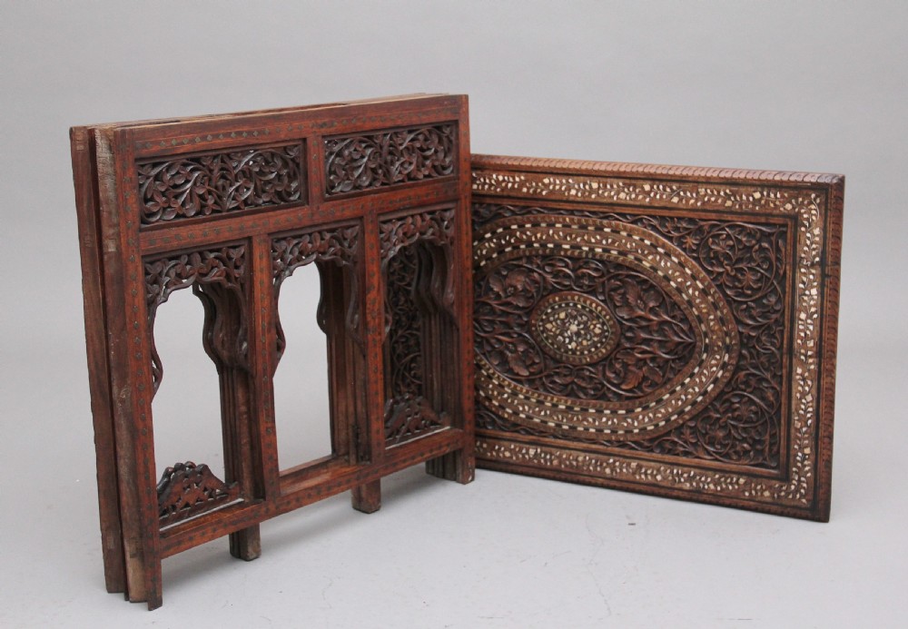 A 19th-century dark hardwood Indian occasional table featuring intricately carved floral fretwork panels, cusped arches, and a geometric bone-inlaid tabletop. View VII