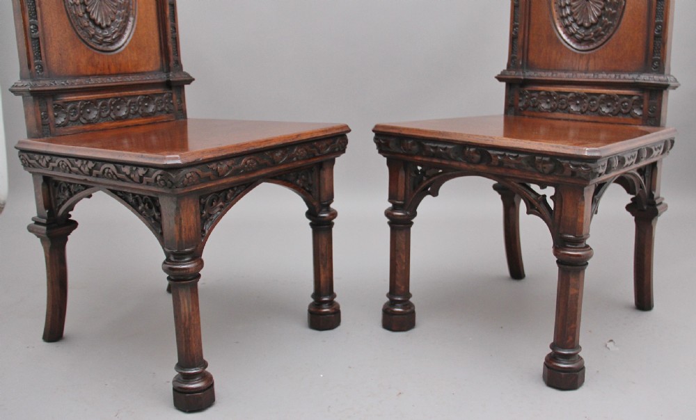 Near pair of 19th Century carved oak Gothic hall chairs View IX