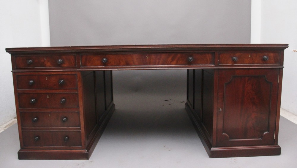 A large and impressive early 20th Century mahogany partners desk View VI