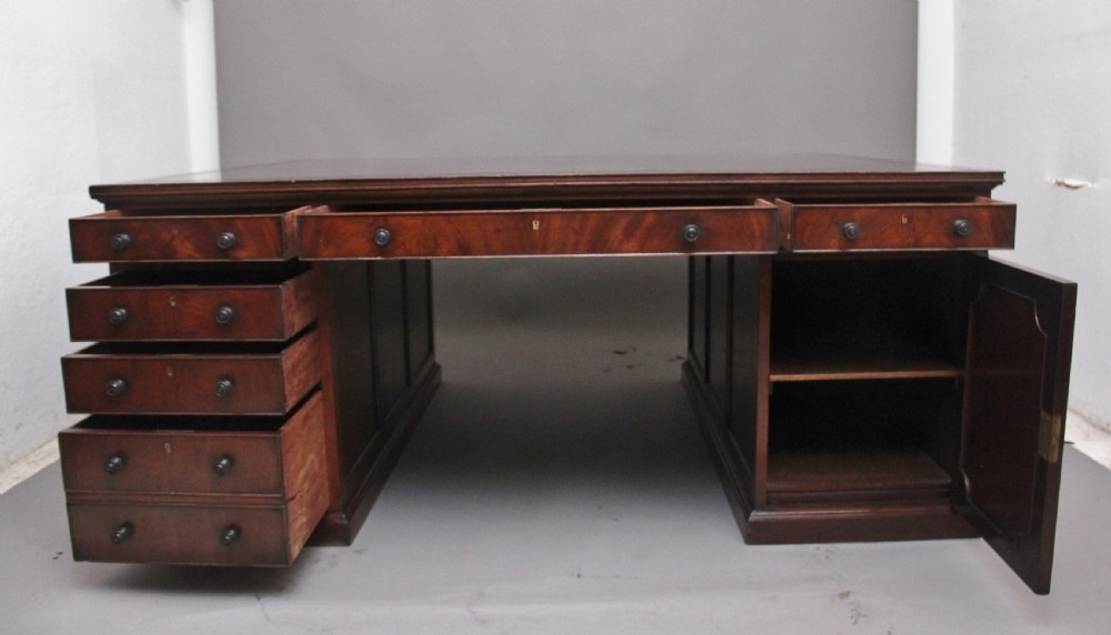 A large and impressive early 20th Century mahogany partners desk View VII