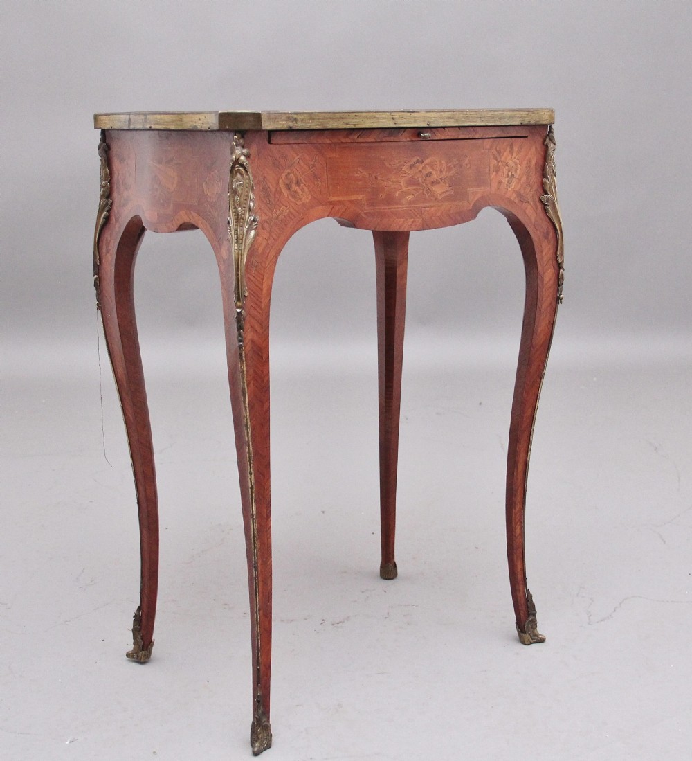 An early 20th-century French kingwood side table featuring slender cabriole legs, floral marquetry inlay, and gilt-metal mounts.
