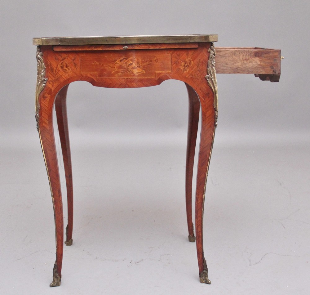 An early 20th-century French kingwood side table featuring slender cabriole legs, floral marquetry inlay, and gilt-metal mounts. View V