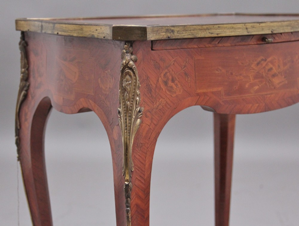 An early 20th-century French kingwood side table featuring slender cabriole legs, floral marquetry inlay, and gilt-metal mounts. View IX