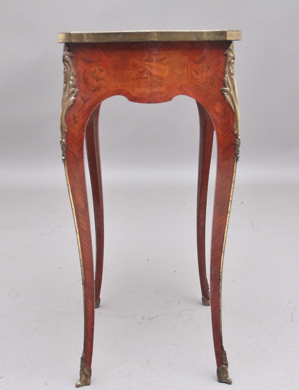 An early 20th-century French kingwood side table featuring slender cabriole legs, floral marquetry inlay, and gilt-metal mounts. View X