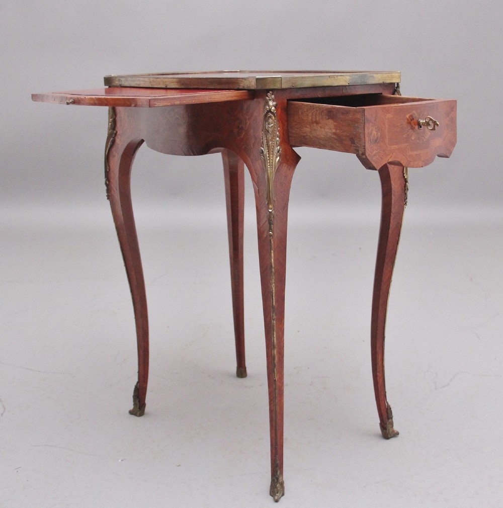 An early 20th-century French kingwood side table featuring slender cabriole legs, floral marquetry inlay, and gilt-metal mounts. View XIV