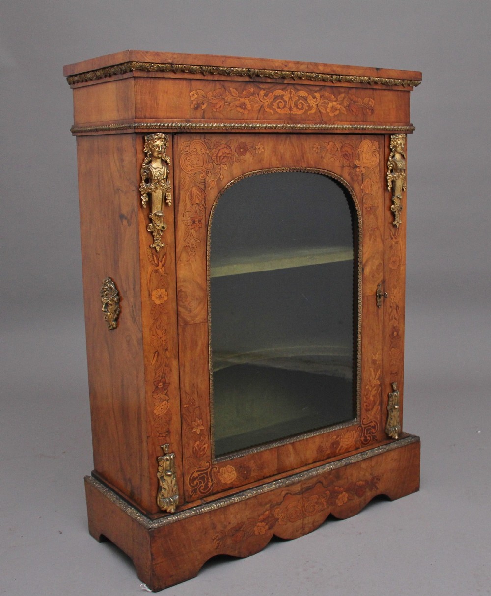 A nineteenth-century walnut pier cabinet featuring intricate floral marquetry, gilt metal mounts, and a central glazed door. View III
