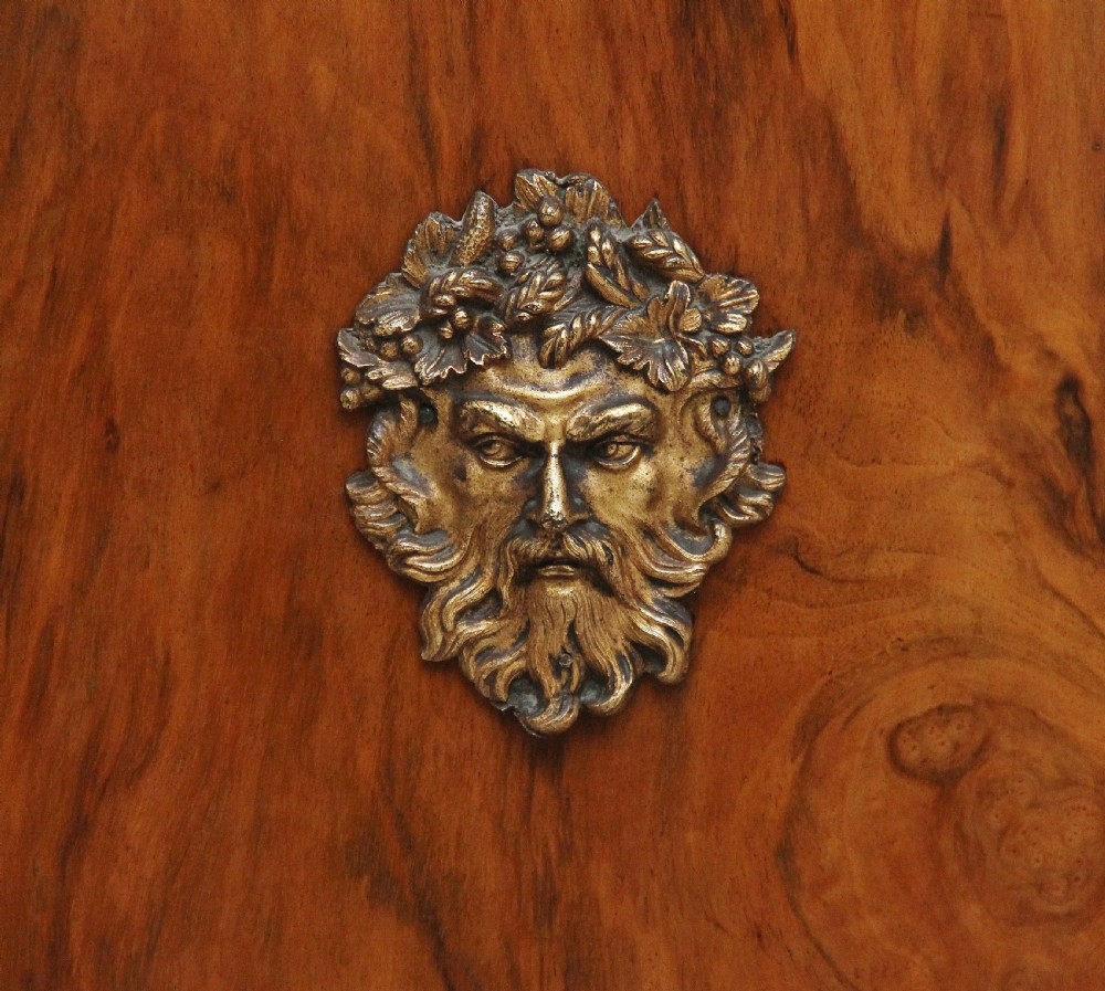 A nineteenth-century walnut pier cabinet featuring intricate floral marquetry, gilt metal mounts, and a central glazed door. View V