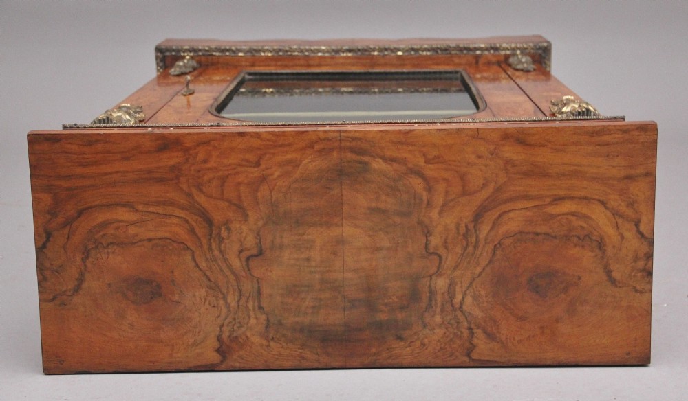 A nineteenth-century walnut pier cabinet featuring intricate floral marquetry, gilt metal mounts, and a central glazed door. View VIII