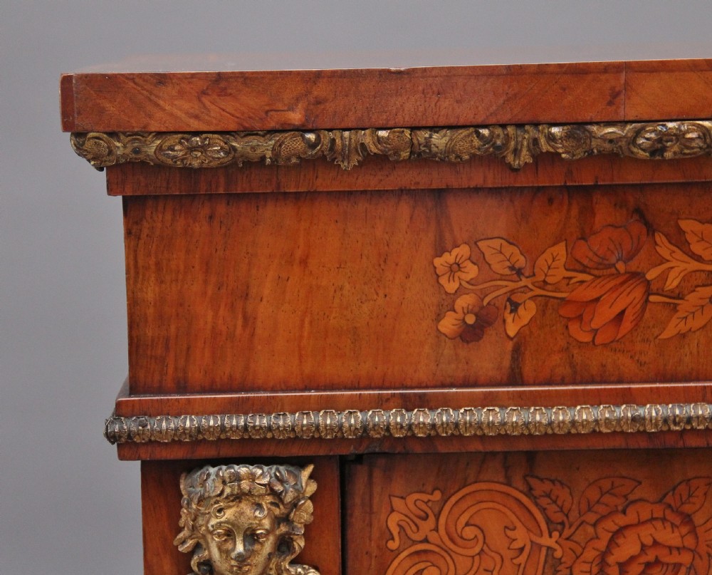 A nineteenth-century walnut pier cabinet featuring intricate floral marquetry, gilt metal mounts, and a central glazed door. View X