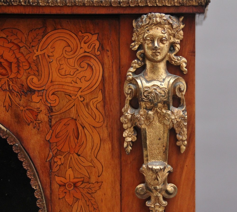 A nineteenth-century walnut pier cabinet featuring intricate floral marquetry, gilt metal mounts, and a central glazed door. View XII