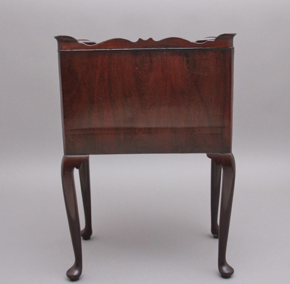 An early 20th-century Georgian-style mahogany bedside cabinet with a scalloped gallery top, open compartment, drawer, brass side handles, and cabriole legs. View VI