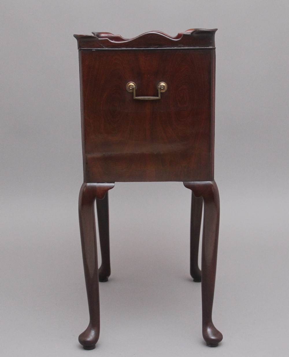 An early 20th-century Georgian-style mahogany bedside cabinet with a scalloped gallery top, open compartment, drawer, brass side handles, and cabriole legs. View VII