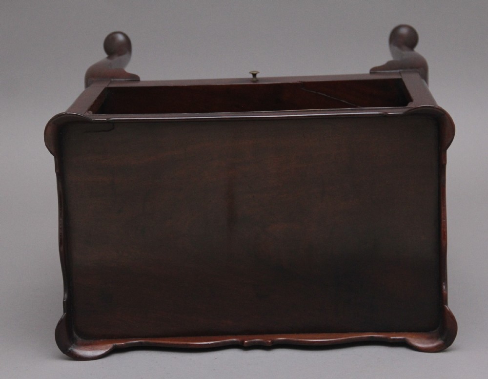 An early 20th-century Georgian-style mahogany bedside cabinet with a scalloped gallery top, open compartment, drawer, brass side handles, and cabriole legs. View VIII