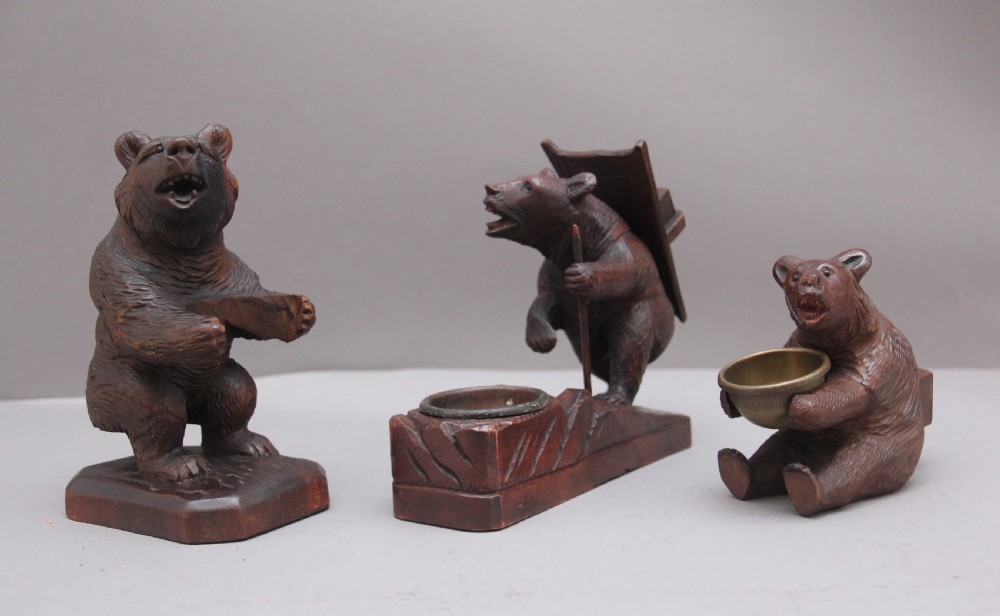 A set of three 19th Century black forest carvings of bears in different poses
